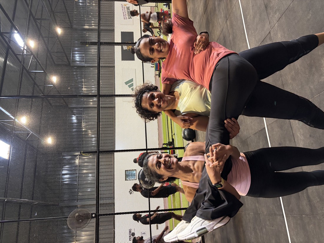 Members laughing while lifting a friend at a LIFTR outdoor event