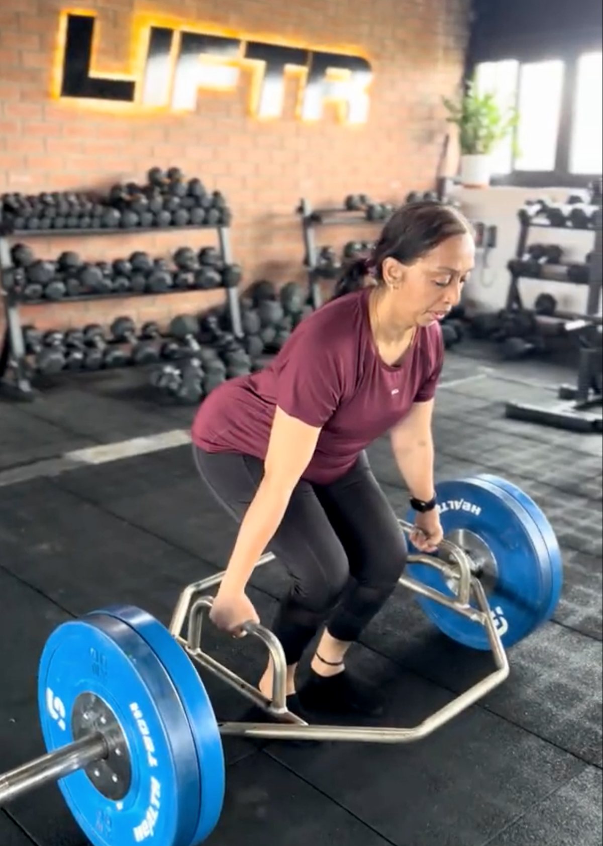 Roopa lifting a trap bar during a coached session